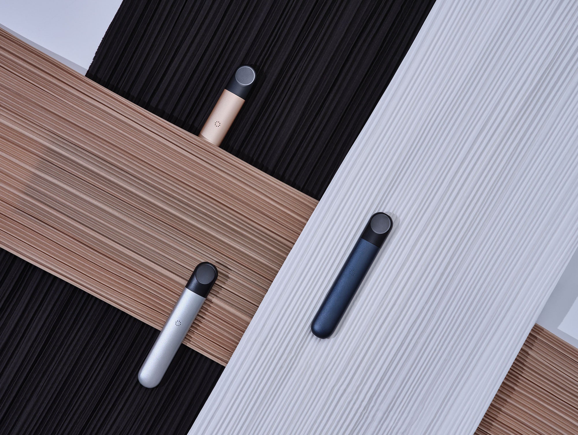 Three RELX Infinity vapes on textured black, brown, and white backgrounds.