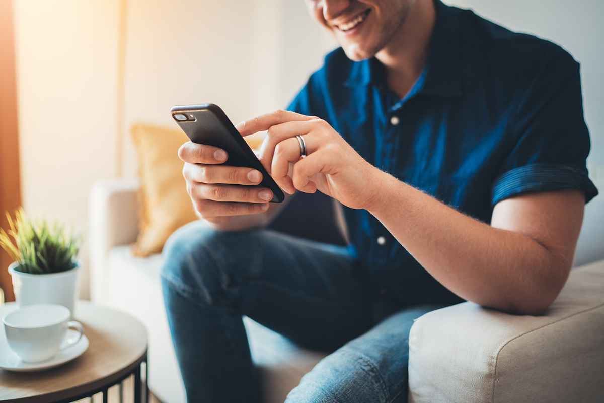 Man browses through online shopping platforms using his phone.