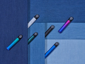 A product shot of six RELX Essential vapes in different colorways against a patterned blue background.