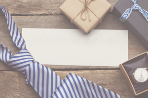 A box of watch and a tie on the wooden table