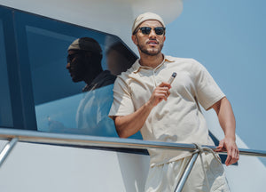 A man holding RELX device on a boat